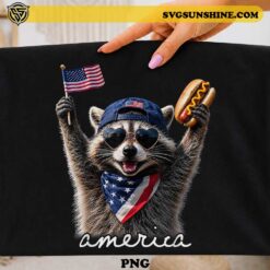 America Feral & Free Raccoon PNG featuring a patriotic raccoon wearing sunglasses, USA hat, American flag bandana, holding a flag and hot dog for Fourth of July t-shirts, sublimation, and Cricut projects.