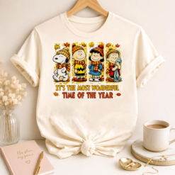 White t-shirt mockup featuring It's The Most Wonderful Time Of The Year Fall Peanuts autumn design with cozy cartoon friends.