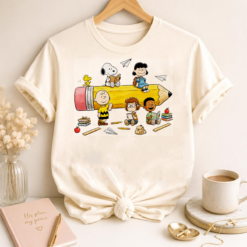 White t-shirt mockup featuring the Peanuts Back To School Pencil PNG design with classroom characters sitting on a giant pencil.