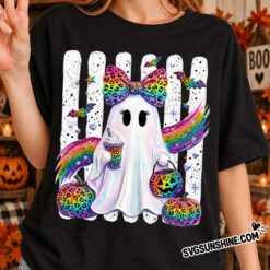 Woman wearing a black t-shirt featuring the Cute Rainbow Ghost Halloween PNG design with rainbow pumpkins and leopard print accents.